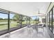 Spacious screened-in lanai with ceiling fan, tiled flooring and views of the private backyard at 1901 E Del Webb Blvd, Sun City Center, FL 33573