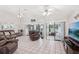 Bright living room boasts tile flooring and sliding glass doors that let in natural light and serene views at 1901 E Del Webb Blvd, Sun City Center, FL 33573