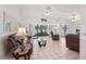 Spacious living room with tile flooring, ceiling fans, and sliding glass doors to lanai with lake views at 1901 E Del Webb Blvd, Sun City Center, FL 33573