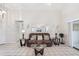 Well-lit living room featuring tile flooring, comfortable seating, and decorative wall mirrors at 1901 E Del Webb Blvd, Sun City Center, FL 33573
