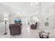 Open floor plan seamlessly connects living area with a partial kitchen view, ideal for entertaining at 1901 E Del Webb Blvd, Sun City Center, FL 33573