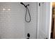 Bathroom shower with white subway tile and black hardware at 2101 Sunset Point Rd # 2304, Clearwater, FL 33765