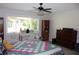 Bedroom featuring natural light, a desk, and hardwood furniture with a comfortable bed at 2101 Sunset Point Rd # 2304, Clearwater, FL 33765