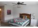 Cozy bedroom featuring a bed with a patterned quilt, a ceiling fan, and a bedside table at 2101 Sunset Point Rd # 2304, Clearwater, FL 33765