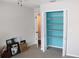 Bedroom with open closet and blue interior at 2101 Sunset Point Rd # 2304, Clearwater, FL 33765