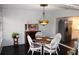 Charming dining room with a round wooden table, seating for four, and a decorative light fixture at 2101 Sunset Point Rd # 2304, Clearwater, FL 33765