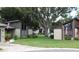 Exterior view of homes with green lawn and landscaping at 2101 Sunset Point Rd # 2304, Clearwater, FL 33765