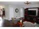 Comfortable living room with hardwood floors, patterned armchairs, and a wooden entertainment center at 2101 Sunset Point Rd # 2304, Clearwater, FL 33765
