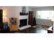 Bright living room with wood floors, fireplace, and comfortable seating arrangements at 2101 Sunset Point Rd # 2304, Clearwater, FL 33765