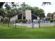 Community pool surrounded by lounge chairs and lush landscaping at 2101 Sunset Point Rd # 2304, Clearwater, FL 33765