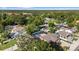 High aerial view of homes in a residential area filled with tall green trees and neighborhood streets at 2233 Curlew Rd, Dunedin, FL 34698