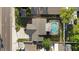 Aerial shot of a home featuring a screened-in pool, a well-maintained lawn, and a paved walkway at 2233 Curlew Rd, Dunedin, FL 34698