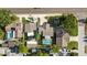 Wide aerial view of the neighborhood showcasing a home with a pool, surrounded by trees and residential properties at 2233 Curlew Rd, Dunedin, FL 34698