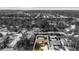 Aerial view of the property featuring a screened-in pool, lawn, and surrounding neighborhood at 2233 Curlew Rd, Dunedin, FL 34698