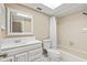 Bathroom features a shower/tub combo, tile surround, a vanity, and a skylight at 2233 Curlew Rd, Dunedin, FL 34698