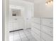 Bathroom featuring tiled floors and a white vanity with a mirror and storage at 2233 Curlew Rd, Dunedin, FL 34698