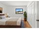 Bright bedroom with a double closet, hardwood floors, and large window with a yard view at 2233 Curlew Rd, Dunedin, FL 34698