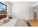 Bright bedroom with a double closet, hardwood floors, and a view of the yard at 2233 Curlew Rd, Dunedin, FL 34698