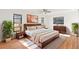 Sunlit main bedroom with hardwood floors and a large bed at 2233 Curlew Rd, Dunedin, FL 34698