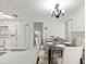Bright dining room features a glass table, decorative chandelier, and neutral color scheme at 2233 Curlew Rd, Dunedin, FL 34698