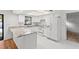 Well-lit kitchen features granite countertops, stainless steel appliances, and ample cabinet space at 2233 Curlew Rd, Dunedin, FL 34698