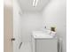 Laundry room with white washer and dryer units at 2233 Curlew Rd, Dunedin, FL 34698