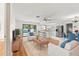 Bright and airy living room next to kitchen and dining area with view of pool and backyard at 2233 Curlew Rd, Dunedin, FL 34698