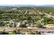 Expansive aerial view of a residential neighborhood with tree-lined streets and various single-Gathering homes at 2233 Curlew Rd, Dunedin, FL 34698