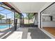 The screened lanai overlooks the pool and backyard and also provides access to the kitchen at 2233 Curlew Rd, Dunedin, FL 34698