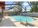 Private screened-in pool offers a relaxing retreat for outdoor enjoyment at 2233 Curlew Rd, Dunedin, FL 34698