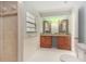 Bathroom with double vanity, vessel sinks, and a tiled shower, providing a spa-like experience at 2308 Long Green Ct, Valrico, FL 33596