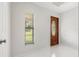 Bright entryway featuring a beautiful wood door, neutral walls and white tile flooring at 2308 Long Green Ct, Valrico, FL 33596