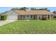 Charming one-story home with a well-manicured lawn, attached garage and inviting front porch at 2308 Long Green Ct, Valrico, FL 33596