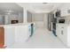 Modern kitchen featuring quartz countertops, stainless steel appliances, and sleek white cabinetry at 2308 Long Green Ct, Valrico, FL 33596