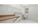 Bright laundry room with storage shelves and a sink near a window, offering a functional space at 2308 Long Green Ct, Valrico, FL 33596
