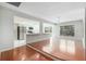 Open-concept living room with hardwood floors and natural light, flowing into the kitchen at 2308 Long Green Ct, Valrico, FL 33596