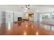 Open-concept living room boasts a stone fireplace, hardwood floors, and built-in bar area at 2308 Long Green Ct, Valrico, FL 33596