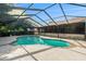 Backyard pool with a screened enclosure, with blue and white tile and a dive board at 2308 Long Green Ct, Valrico, FL 33596