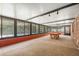 Enclosed recreation room with a pool table, and floor-to-ceiling windows overlooking the pool area at 2308 Long Green Ct, Valrico, FL 33596