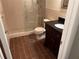 Bathroom showcasing a stand up shower with an ornate sliding door and an updated vanity at 2410 Franciscan Dr # 18, Clearwater, FL 33763