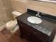 A bathroom featuring a dark vanity top, glass shower and wood-look tile flooring at 2410 Franciscan Dr # 18, Clearwater, FL 33763