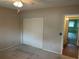 Bedroom with a ceiling fan, closet, and view to the hallway at 2410 Franciscan Dr # 18, Clearwater, FL 33763