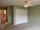 A bedroom featuring neutral walls, carpeted floor, ceiling fan, and a standard double-door closet at 2410 Franciscan Dr # 18, Clearwater, FL 33763