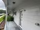 Unit exterior with a covered porch and a view of a grassy common area at 2410 Franciscan Dr # 18, Clearwater, FL 33763