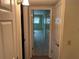 Hallway featuring multiple storage closets and a view into a bedroom with natural light at 2410 Franciscan Dr # 18, Clearwater, FL 33763