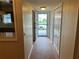Hallway featuring wood floors, neutral walls, closet space, and a bright view outside at 2410 Franciscan Dr # 18, Clearwater, FL 33763