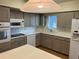 Kitchen with gray cabinets, quartz countertops, and a view to the outside at 2410 Franciscan Dr # 18, Clearwater, FL 33763