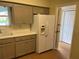 Kitchen featuring gray cabinets, a refrigerator with a water dispenser, and a doorway at 2410 Franciscan Dr # 18, Clearwater, FL 33763