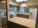 Kitchen showcasing stainless appliances, countertops, and a breakfast bar overlooking an adjacent space at 2410 Franciscan Dr # 18, Clearwater, FL 33763