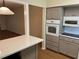 Kitchen featuring quartz countertops, stainless appliances, and a view into an adjacent space at 2410 Franciscan Dr # 18, Clearwater, FL 33763